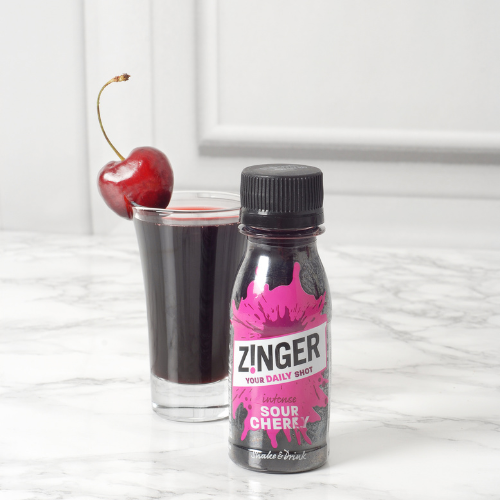 Sour Cherry Zinger shot with a glass filled with the drink
