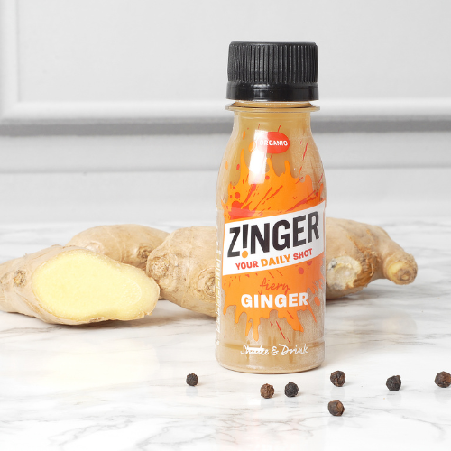 Organic Ginger Zinger on a table with ginger root