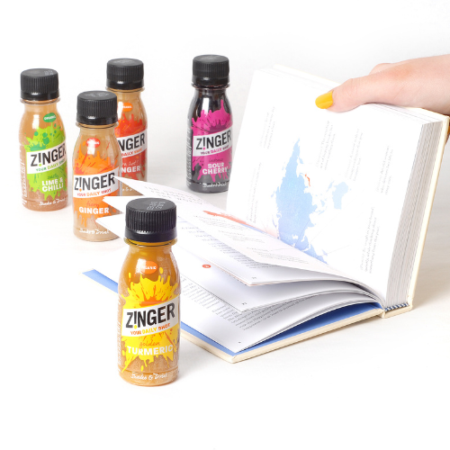 Hand opening a book with the Zinger shot range