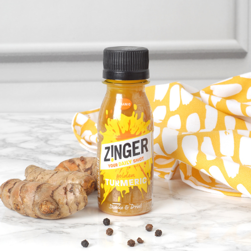 Organic Turmeric Zinger Shot with a bright fabric and ingredients