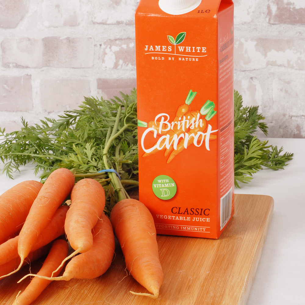 
                  
                    British Carrot juice carton with some fresh carrots 
                  
                