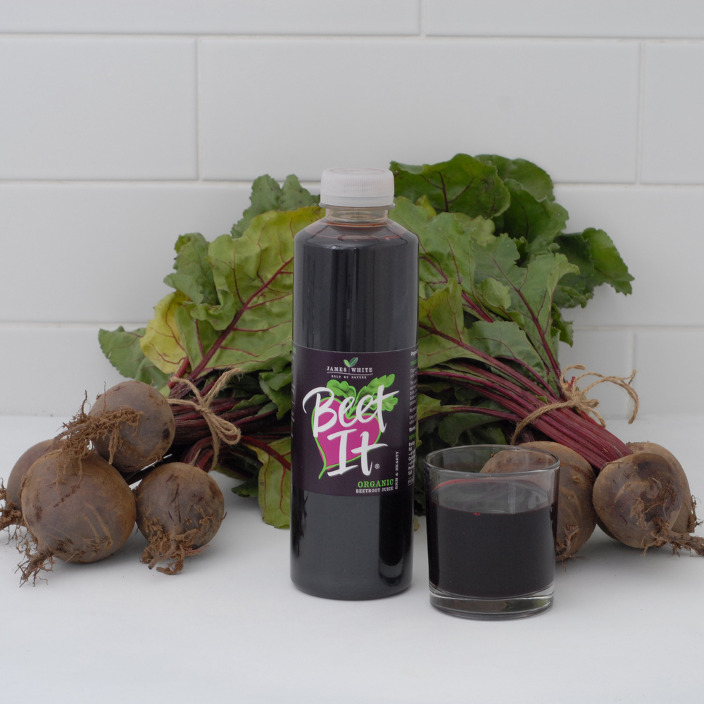 Beet It Organic Juice plastic bottle with a glass of juice and beetroots 